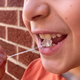 A student demonstrating the use of one of the team’s models. The string helps ensure that kids don’t swallow the model when playing with it.